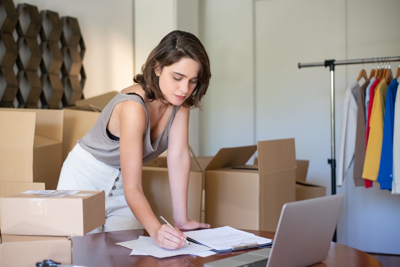 Small business owner managing online orders and product inventory